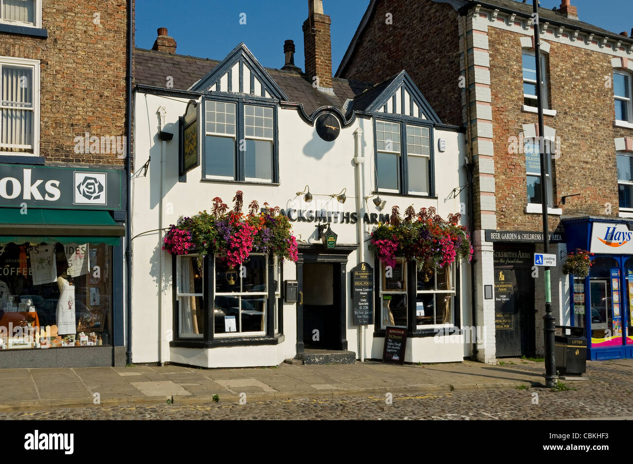 The Blacksmiths Arms pub public house in summer Market Place Thirsk North Yorkshire England UK United Kingdom GB Great Britain Stock Photo