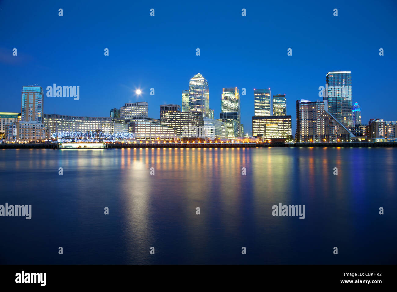 Full moon over London skyscrapers in Docklands Stock Photo - Alamy