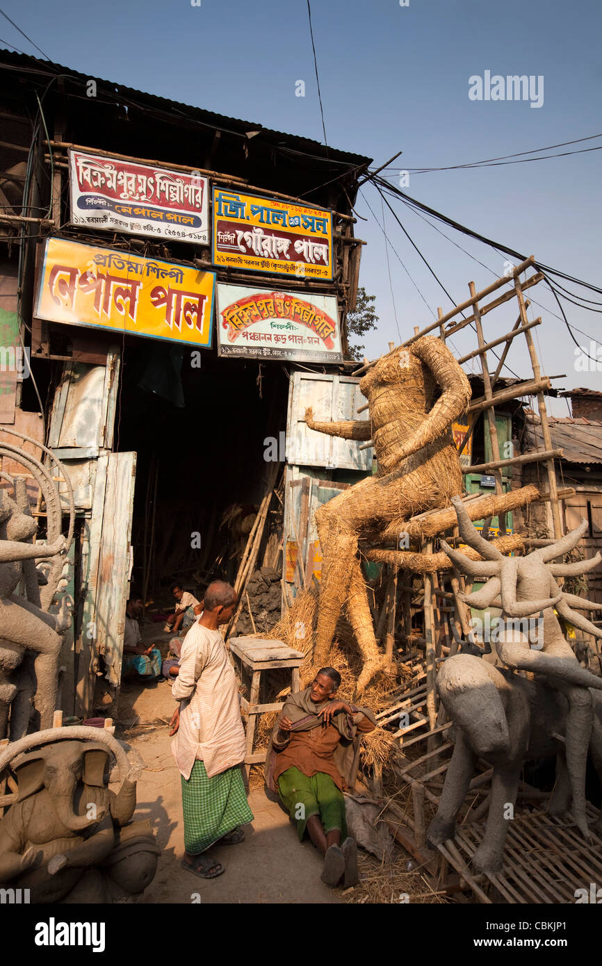 India, West Bengal, Kolkata, Kumartuli, sculptors’ enclave, part-completed clay puja effigies on straw body Stock Photo