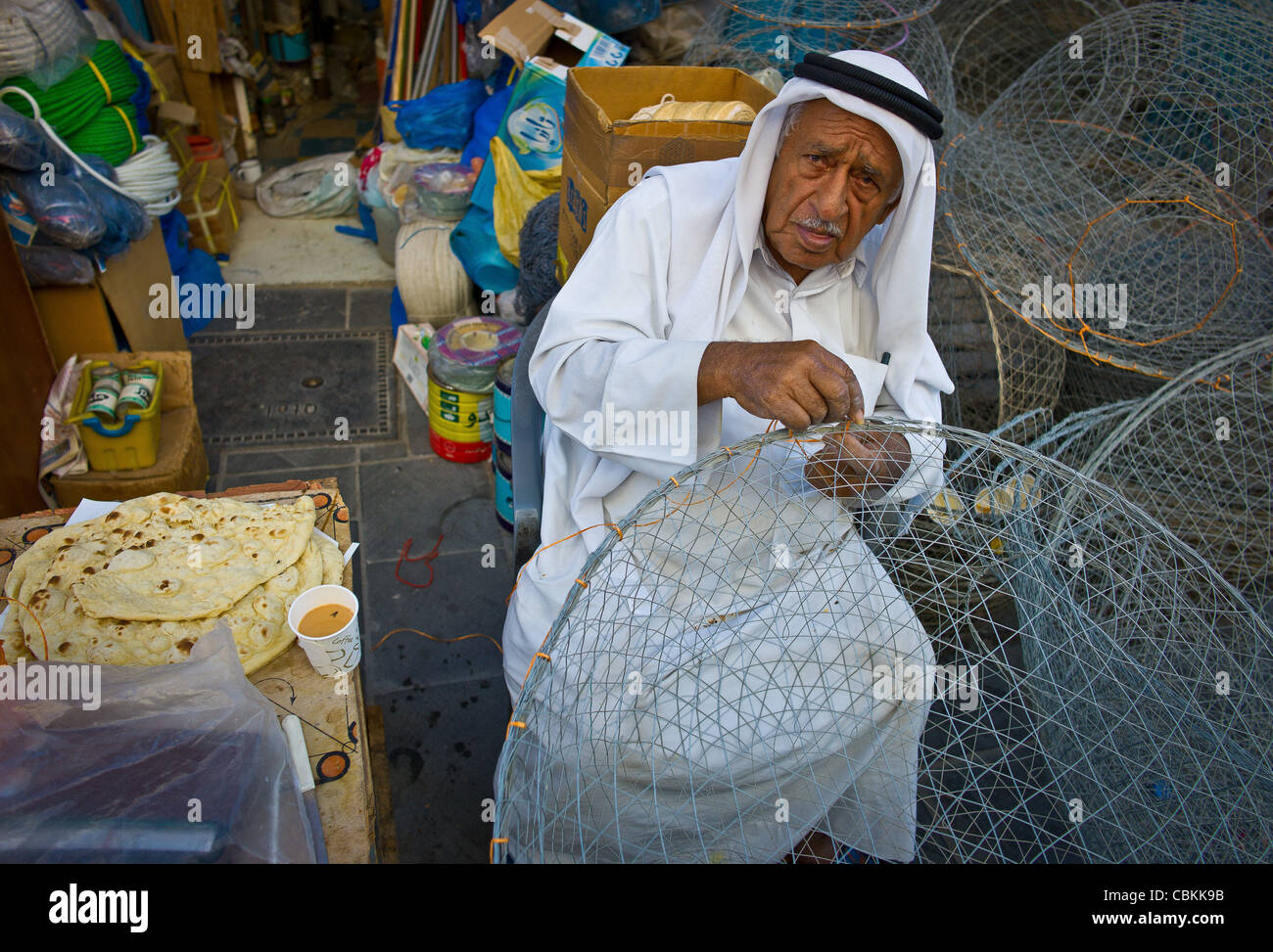 Doha , Qatar, Qatari old men , mending a basket of Fishing in Doha Souq