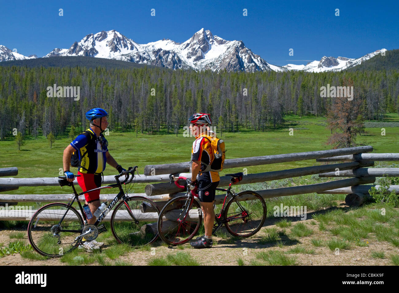 Touring bicyclists stop for a view of the Sawtooth Mountain Range near Stanley, Idaho, USA. Stock Photo