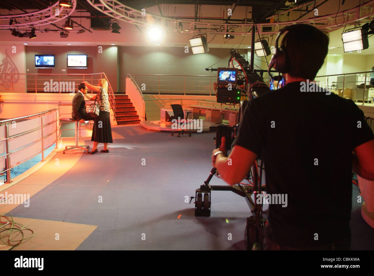 Al Jazeera English anchor delivering the news at the Doha HQ of AJE ...