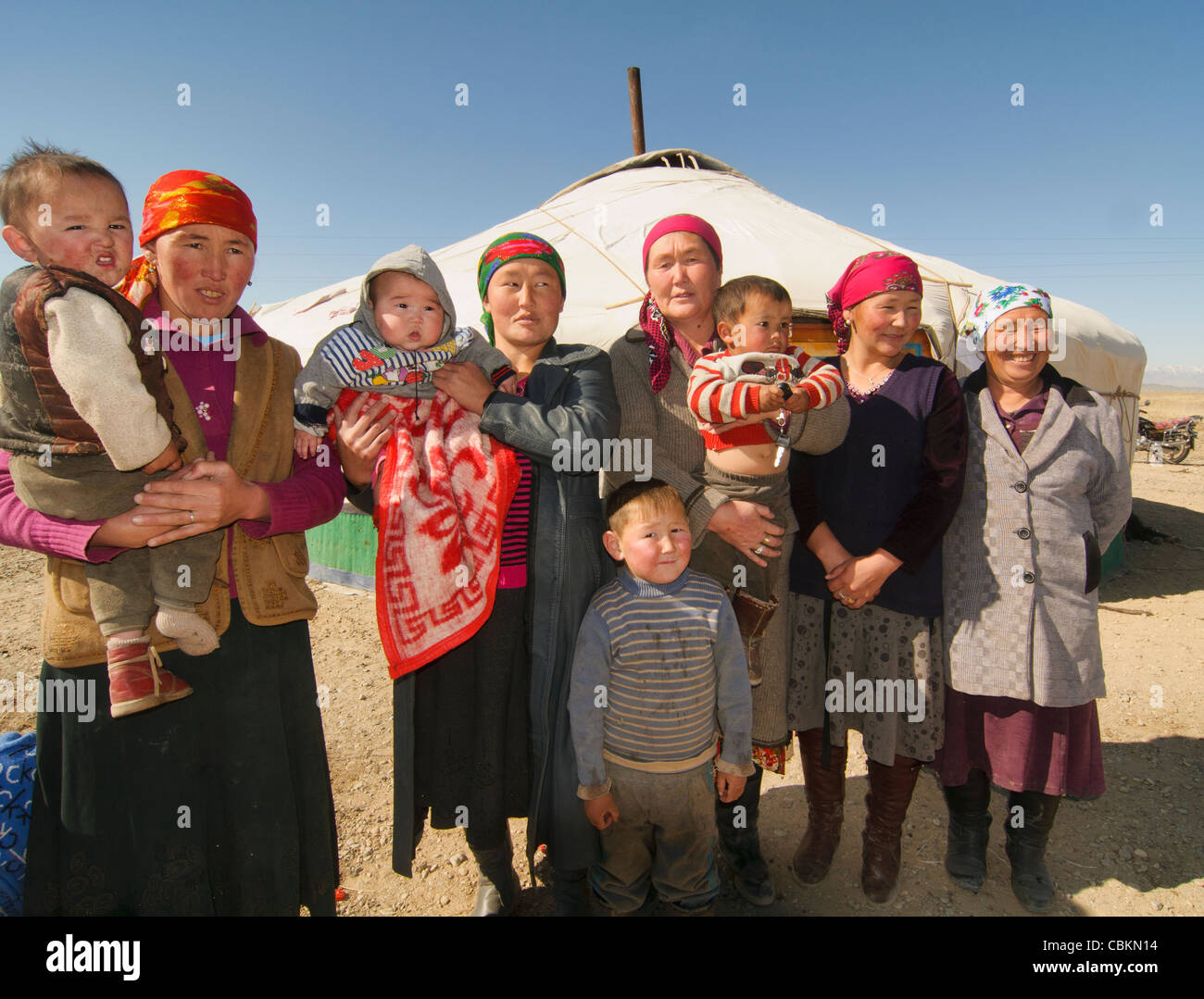 Kazakh eagle hunter's family in front of their ger (yurt) in the Altai ...