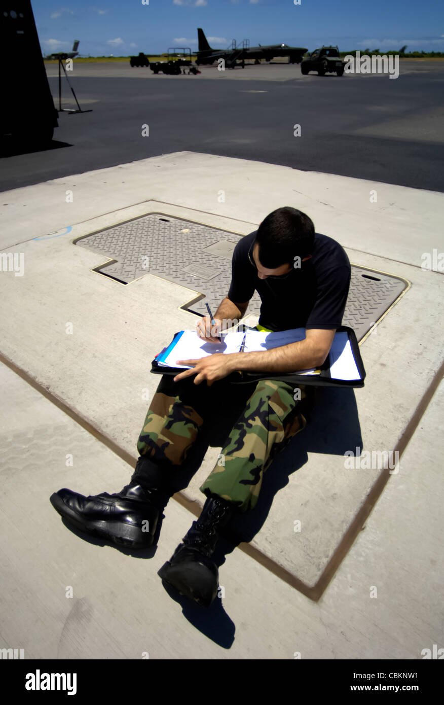 Staff Sgt. Andrew Di Betta annotates his maintenance log for a U-2 Dragon Lady at Hickam Air Force Base, Hawaii, on Tuesday, June 13. The aircraft is en route to South Korea. U-2s are undergoing a $1.5 billion upgrade. Cockpit instruments will be modernized with full-color displays that replace gauges and dials with state-of-the-art, touch-screen technology. Sergeant Di Betta is a crew chief with the 9th Maintenance Squadron at Beale Air Force Base, Calif. Stock Photo