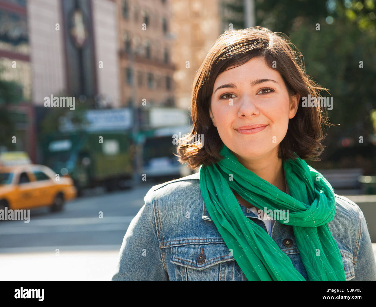 Young woman smiling in street, portrait Stock Photo - Alamy