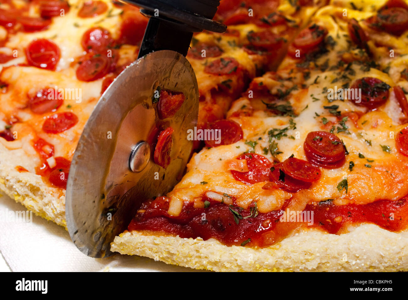 Cutting pepperoni pizza Stock Photo Alamy