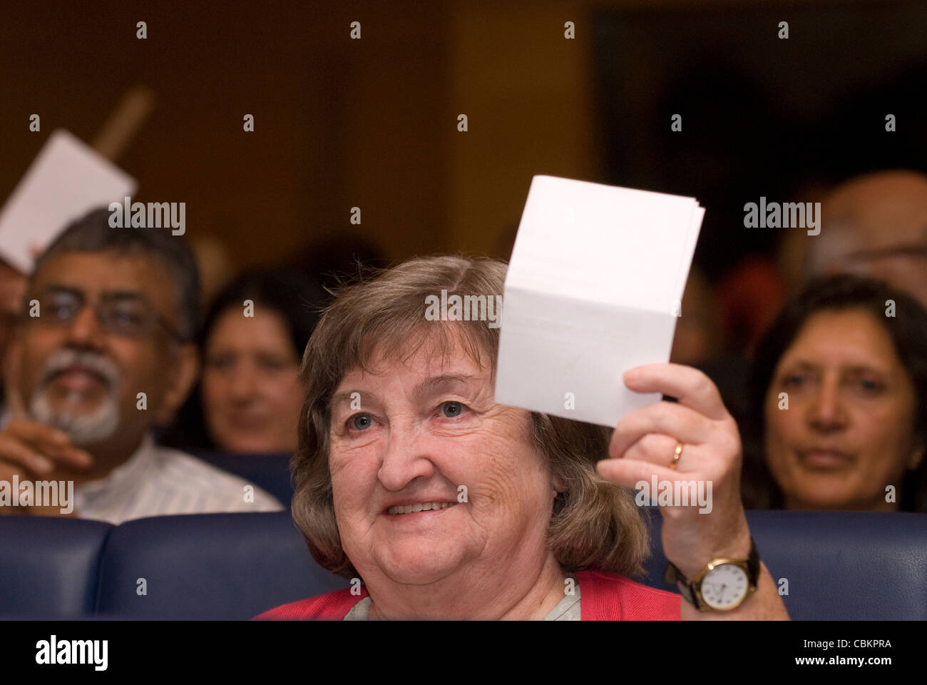 Delegates voting on a motion at a conference for people who care for dependant friends and families, London, UK. Stock Photo