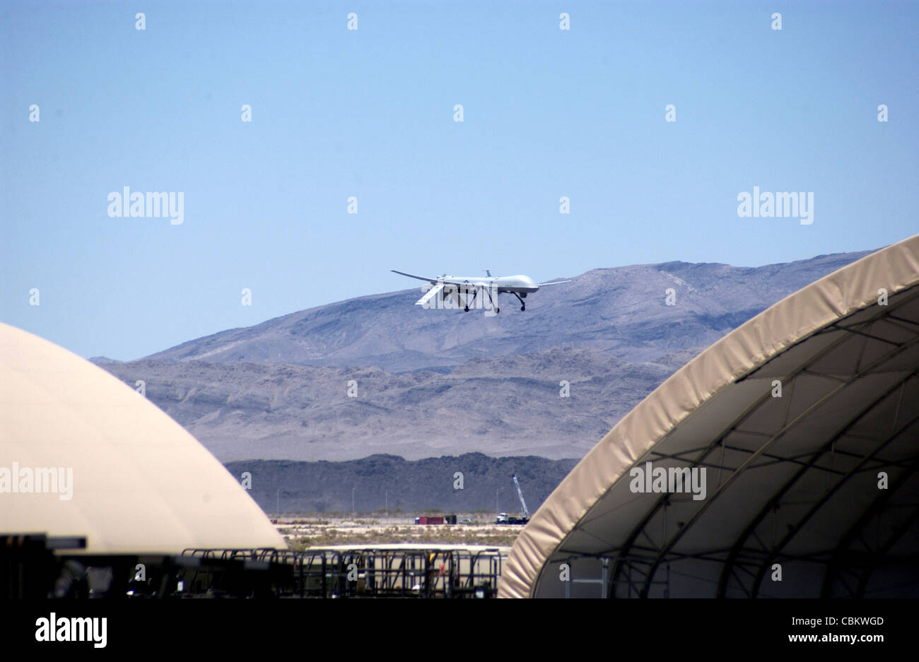 An MQ-1 Predator conducts a low pass commemorating the 250,000th flight hour of the airframe June 22 at Creech Air Force Base, Nev. The Predator is assigned to the 11th Reconnaissance Squadron at Creech AFB. When the Predator is not actively pursuing its primary mission, it acts as the joint forces air component commander-owned theater asset for reconnaissance, surveillance and target acquisition in support of the joint forces commander. Stock Photo