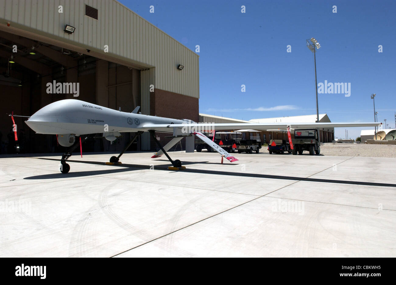 An MQ-1 Predator sits on display after commemorating the 250,000th flight hour June 22 at Creech Air Force Base, Nev. The Predator is assigned to the 11th Reconnaissance Squadron at Creech AFB. The MQ-1 Predator is a medium-altitude, long-endurance, remotely piloted aircraft. Its primary mission is interdiction and conducting armed reconnaissance against critical, perishable targets. Stock Photo