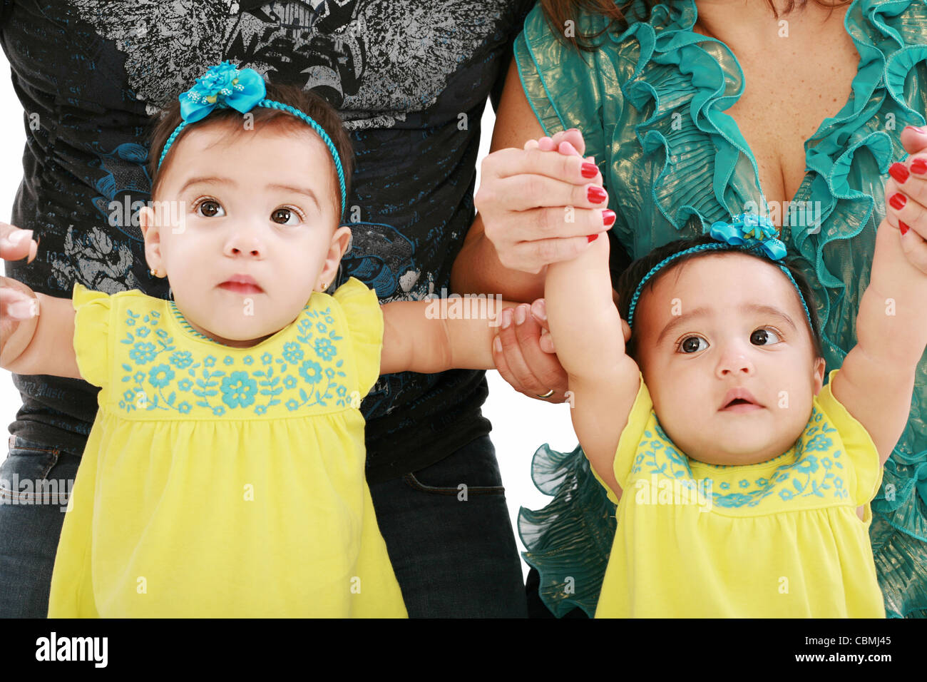 Dad and mom holding her twin babies girl Stock Photo Alamy