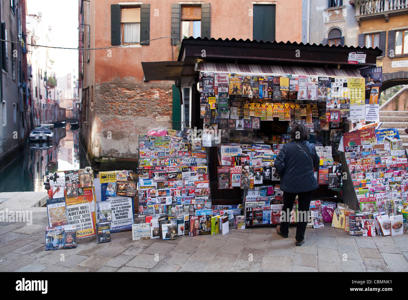 Woman looks at newspaper magazine kiosk in venice hi-res stock ...