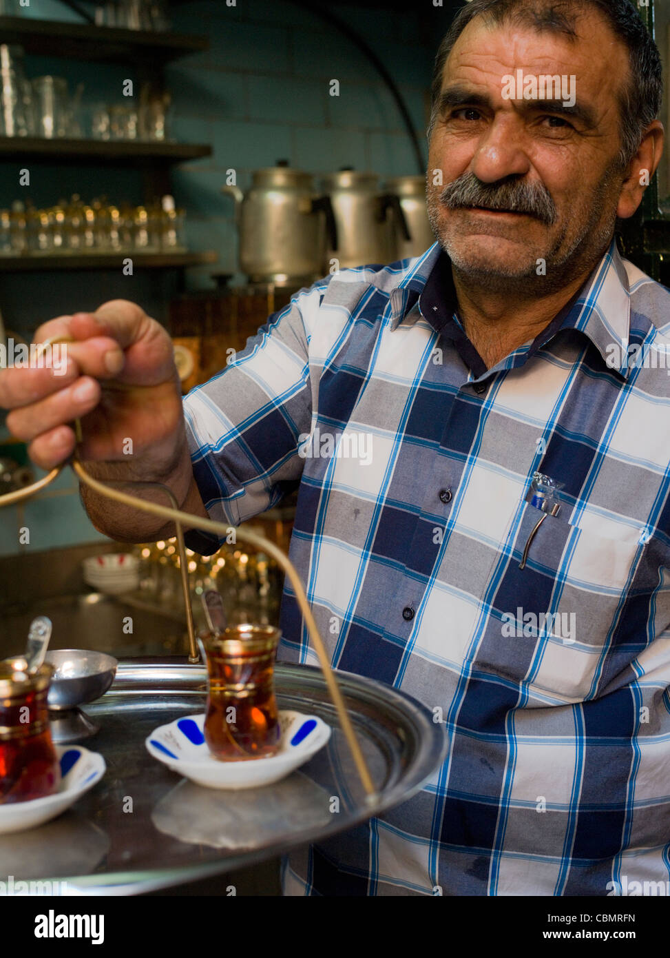 Man delivering turkish tea to the stores in The Grand Bazaar, Istanbul a covered market. Stock Photo
