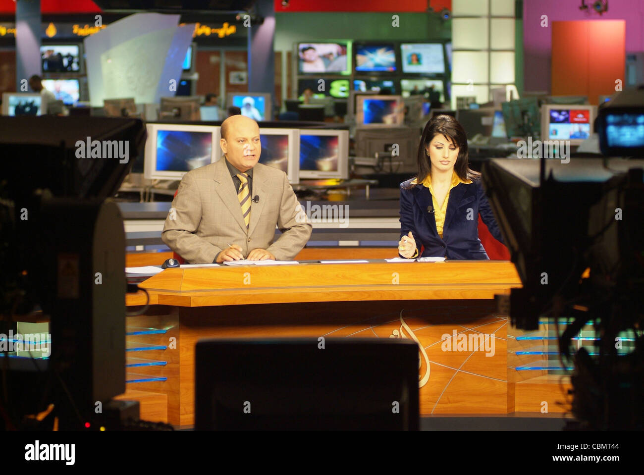 Al Jazeera satellite TV anchors Habib Ghribi and Lina Zahreddine read Stock Photo: 41639924 - Alamy