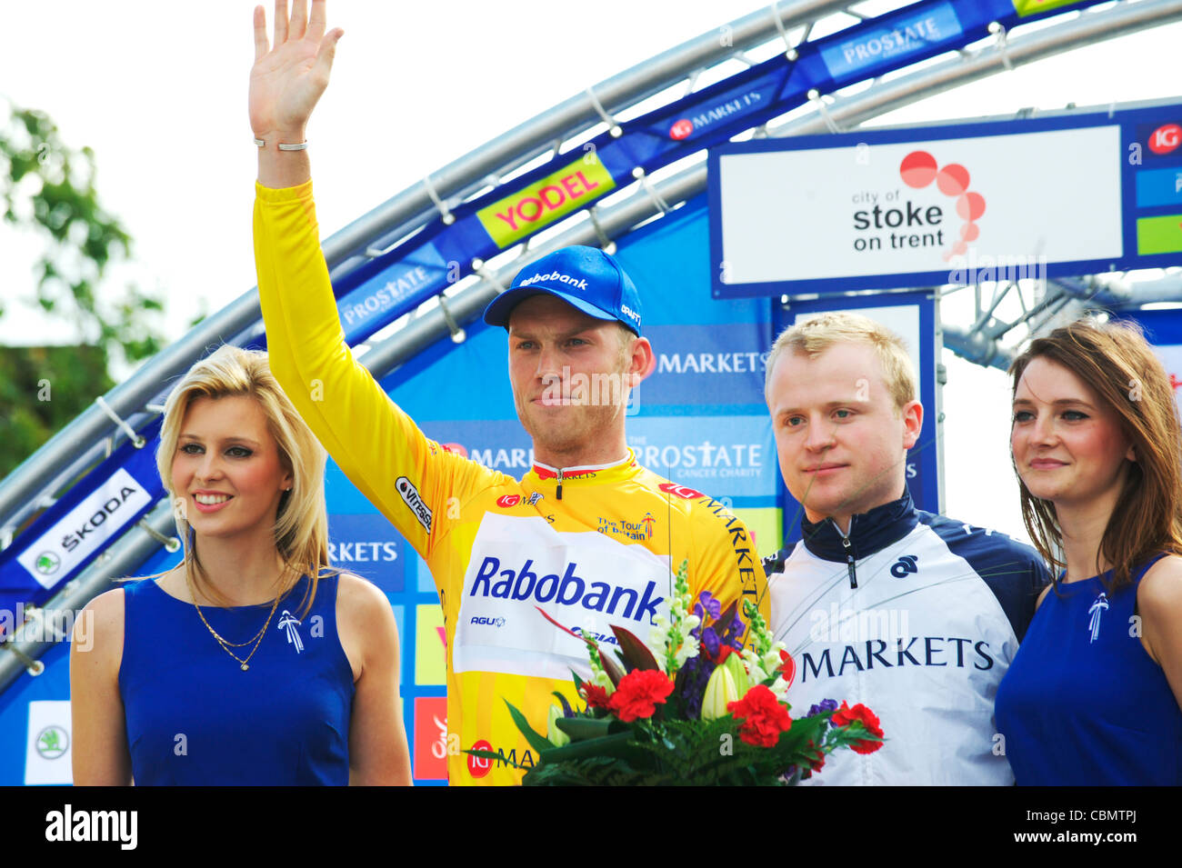 Overall leader of the Tour of Britain, Lars Boom celebrates on the stage wearing his yellow jersey on stage in Stoke Stock Photo