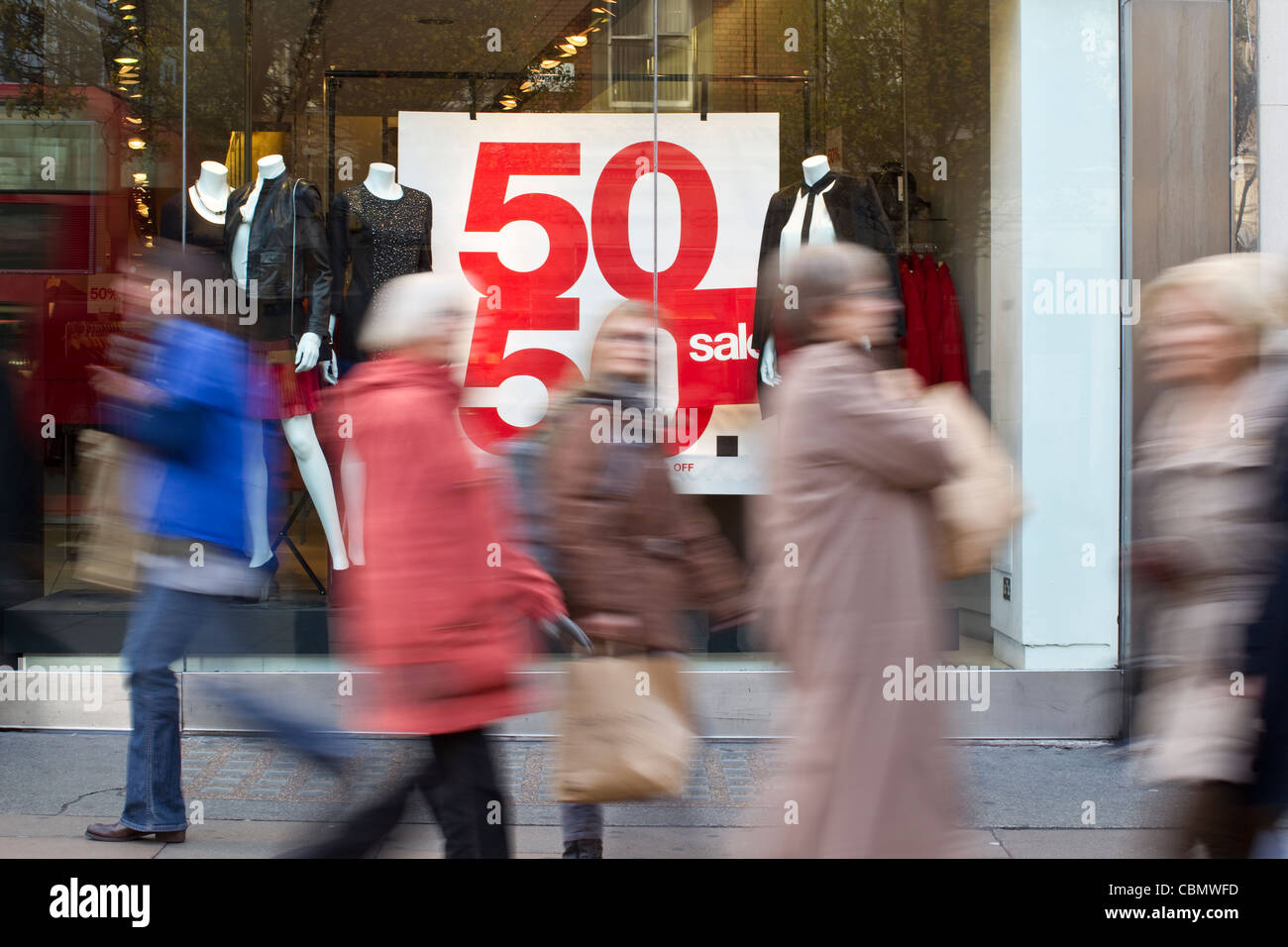 PreChristmas Sale signs in shop windows on Oxford Street, London