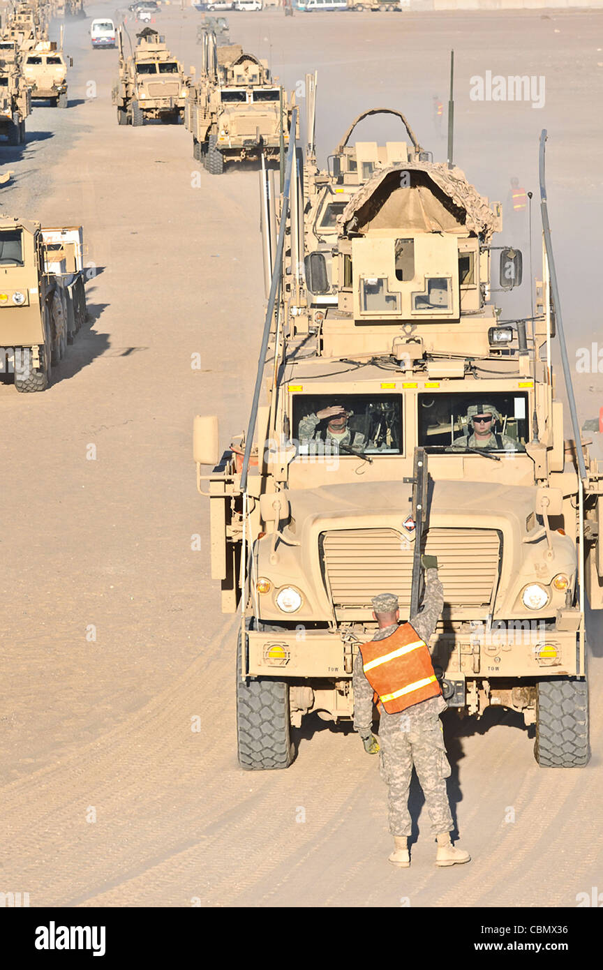 A US soldier guides armored vehicles for loading back to the US as part of the final withdraw of forces from Iraq December 10, 2011 at Camp Virginia, Kuwait. The US is completing their 8-year mission in Iraq at the end of December. Stock Photo