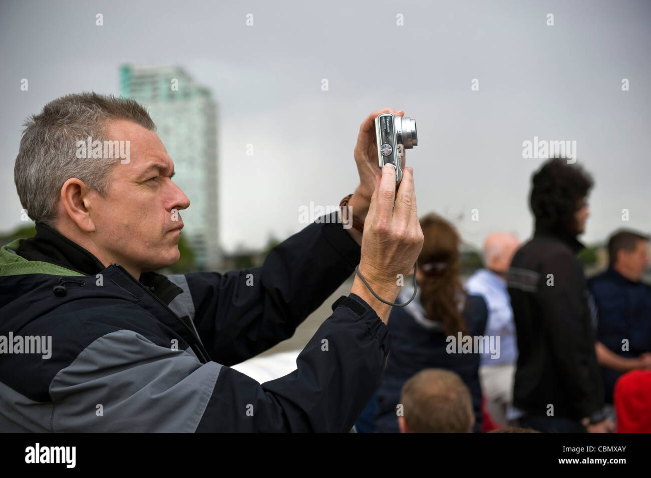 Sightseers on a Thames River boat guided tour, London, UK Stock Photo