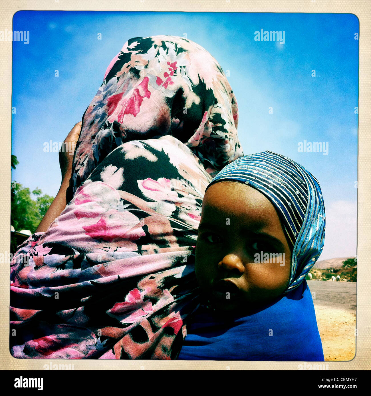 Portrait Of Young Boy Hung On Mother Back Burao Somaliland Stock Photo