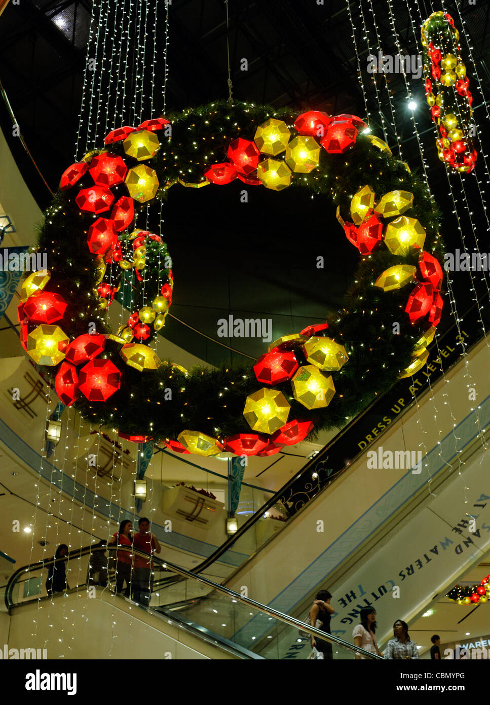 Illuminated Christmas garlands form the decorations for Raffles City shopping mall in Singapore Stock Photo