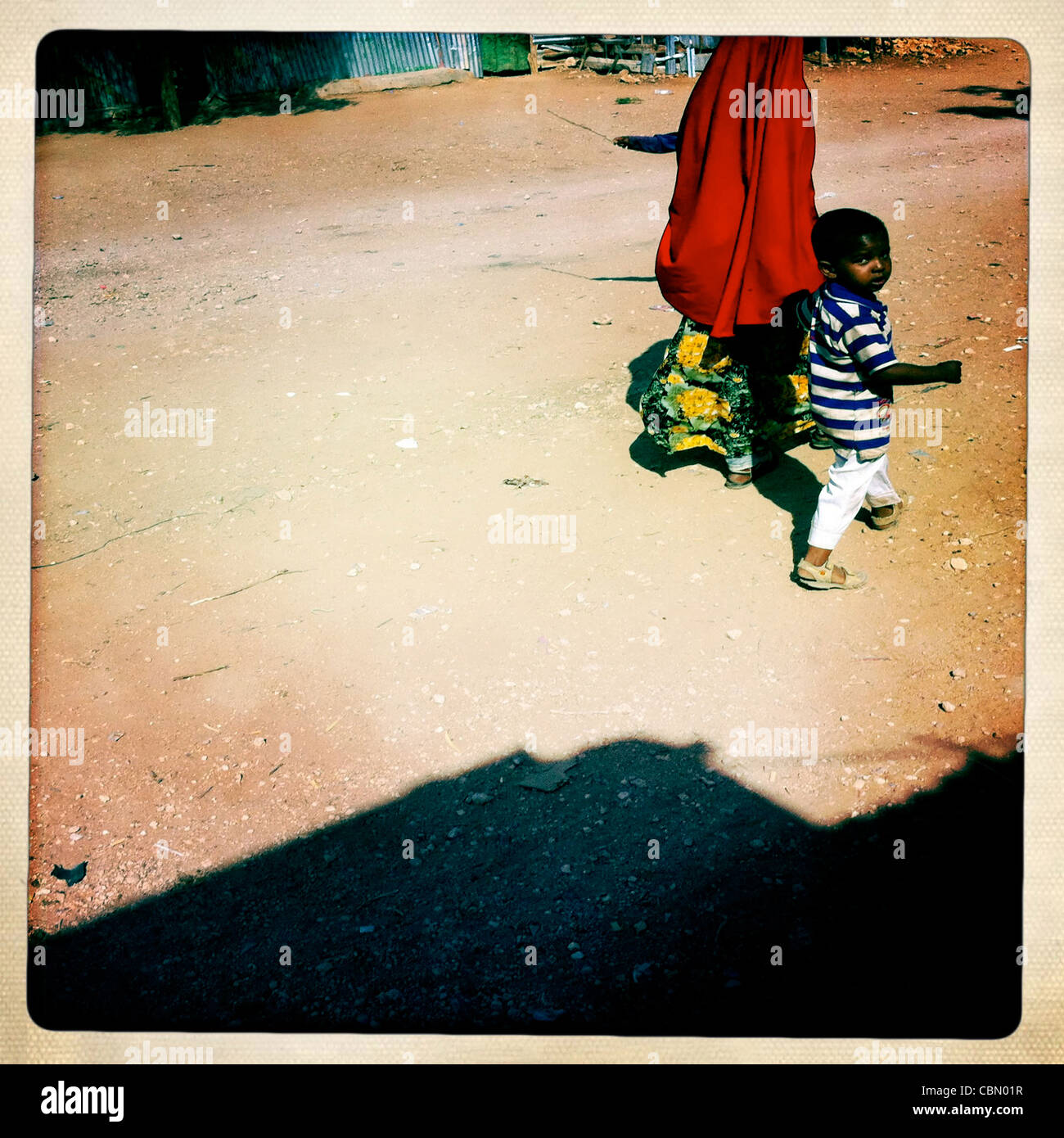 Little Boy Passing With His Mom By The Street Of Baligubadle Somaliland Stock Photo