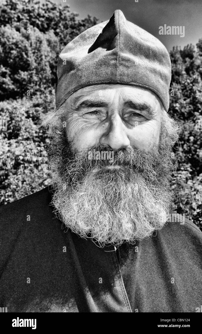 Portrait of Russian Orthodox priest in red hat in country of Lviv