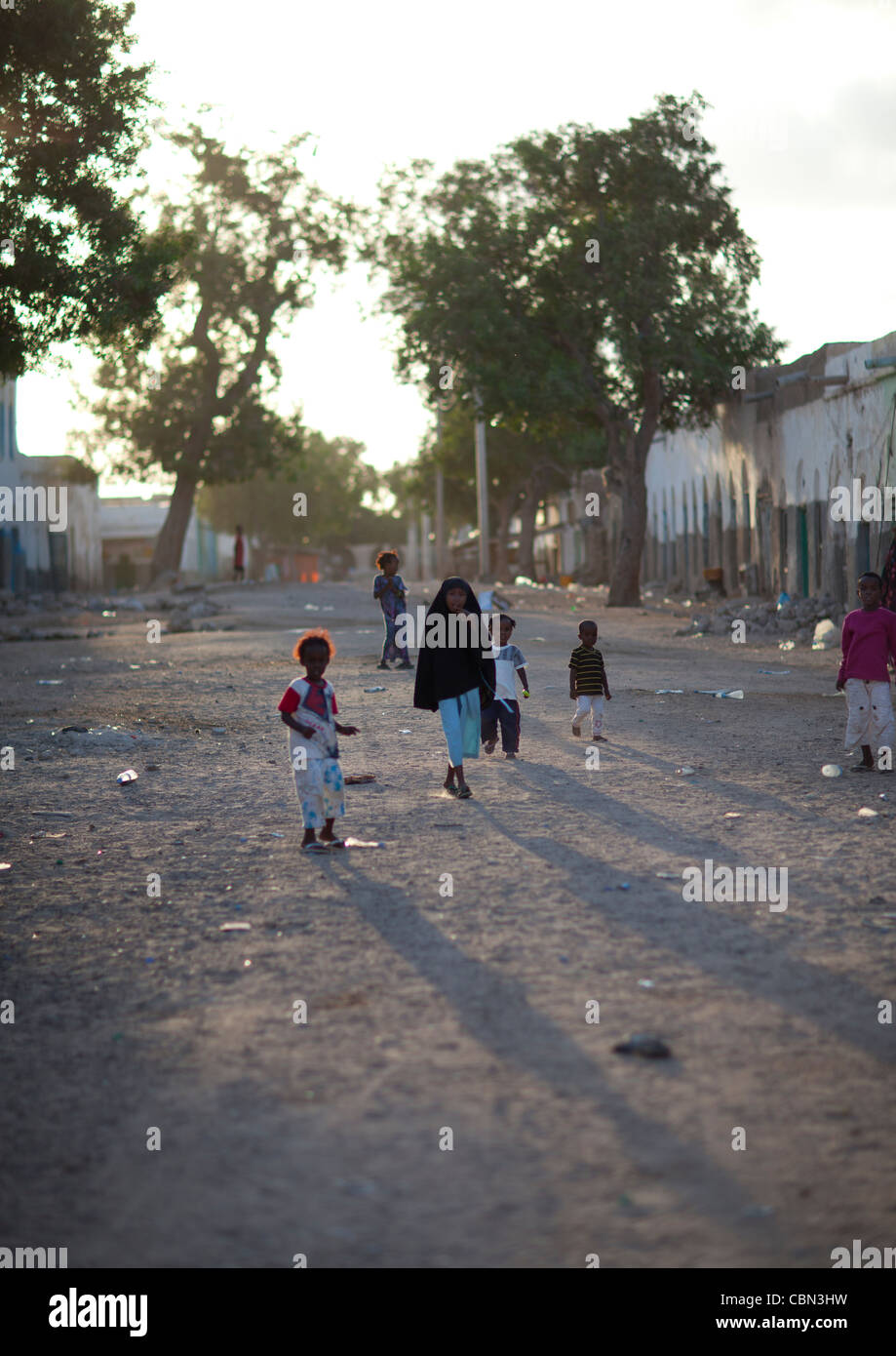 Children Playing In A Clay Ground Street At End Of Day, Berbera Somaliland Stock Photo