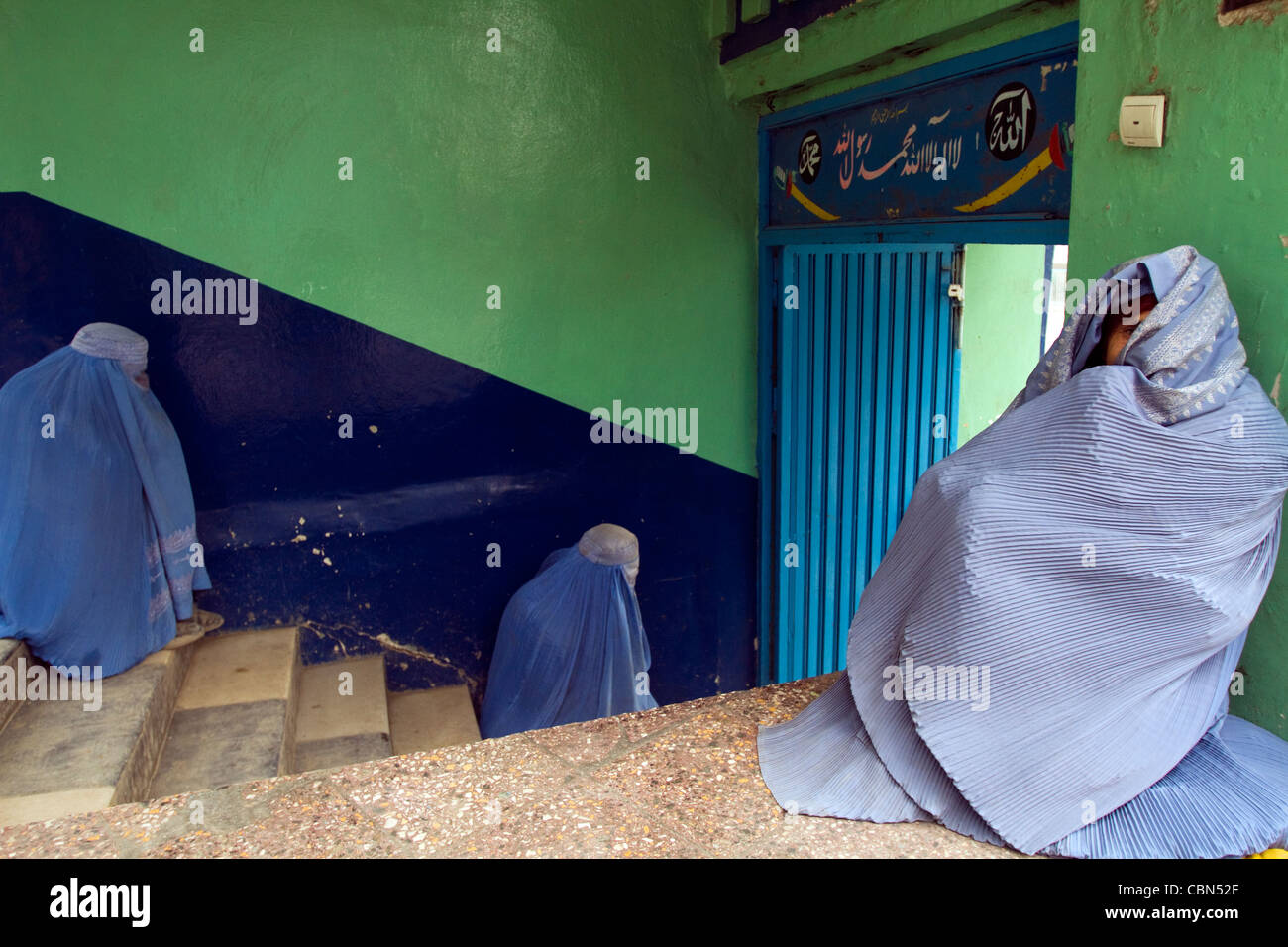 Women in burka waiting for their husband or brothers to go out in Kabul Afghanistan Stock Photo