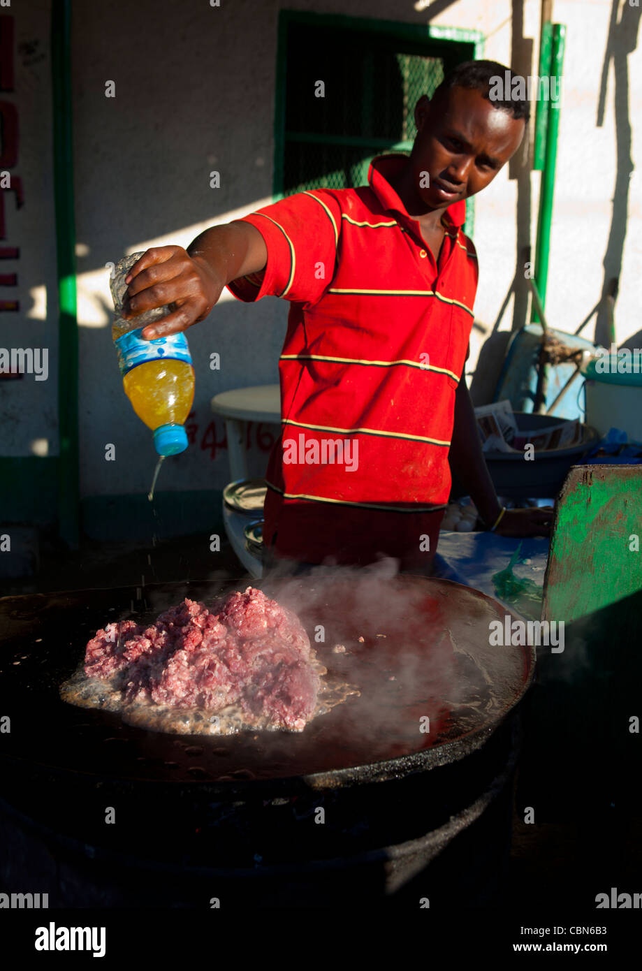 Young Man Cooking Red Meat Outdoors Boorama Somaliland Stock Photo