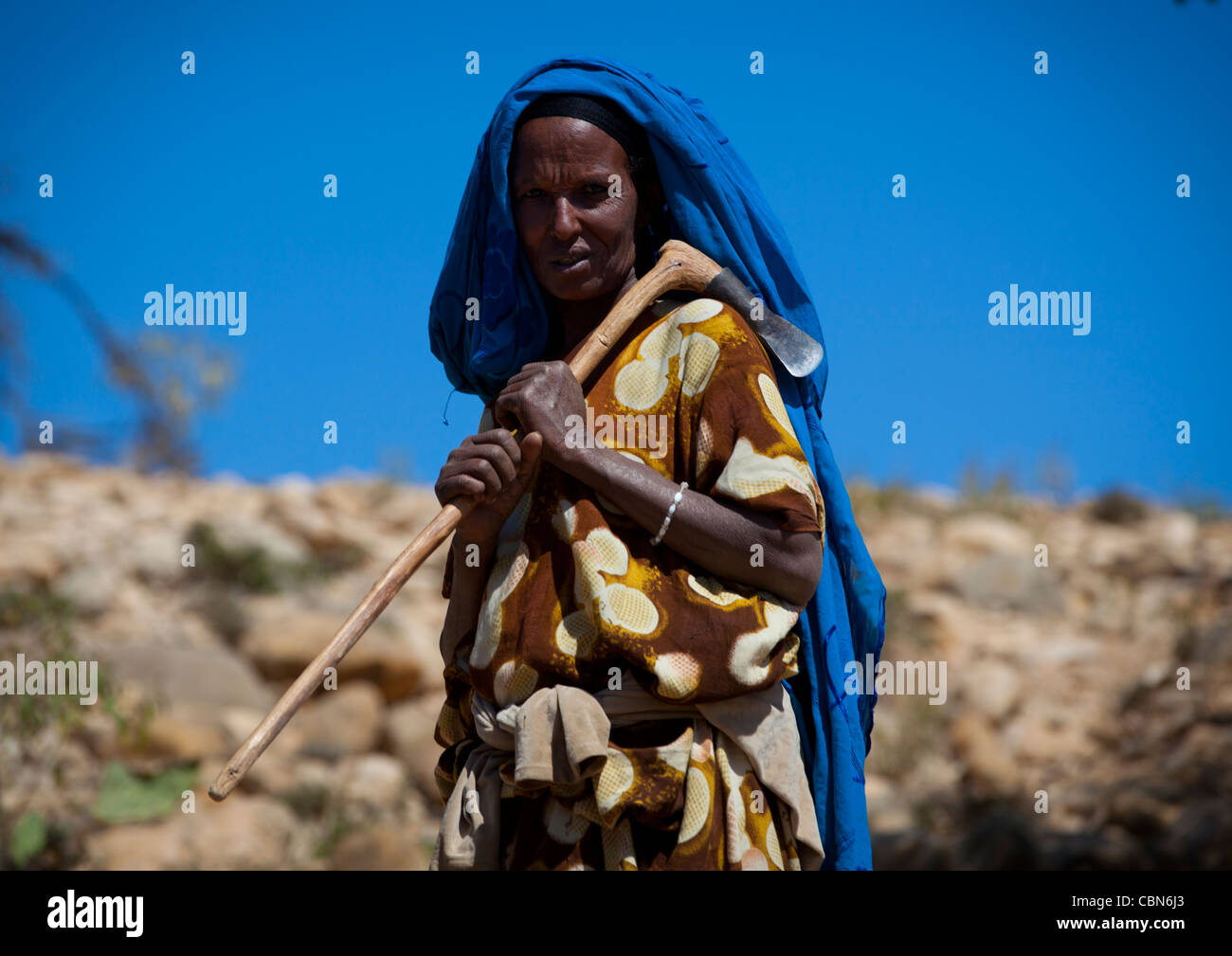 Nomad Mature Woman Scarf On Head And Axe In Hand Head And Shoulders Portrait Somaliland Stock Photo