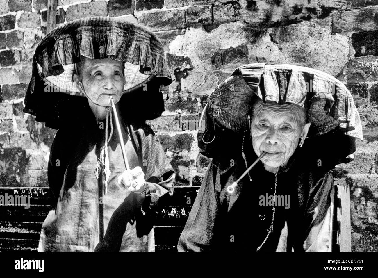 Old Hakka woman with pipe in the old walled city of Kam Tin in the New Territories area of Hong Kong. This is a dying breed Stock Photo