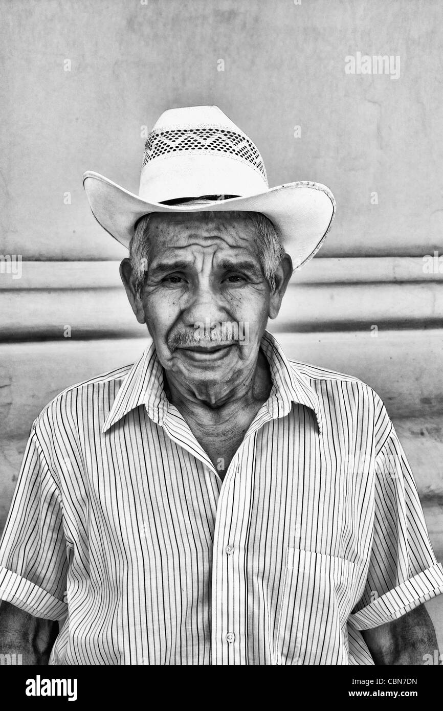 Local colorful man against bright wall with cowboy hat in tourist village of Antigua Guatemala Stock Photo