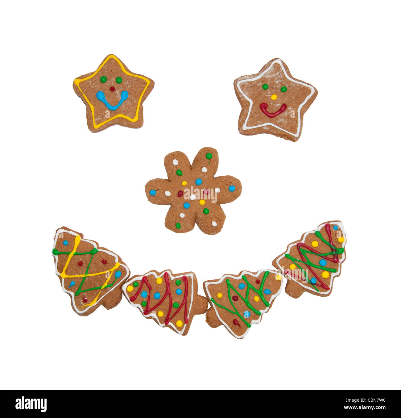 Colorful Christmas cookies forming a smiling face on white background Stock Photo