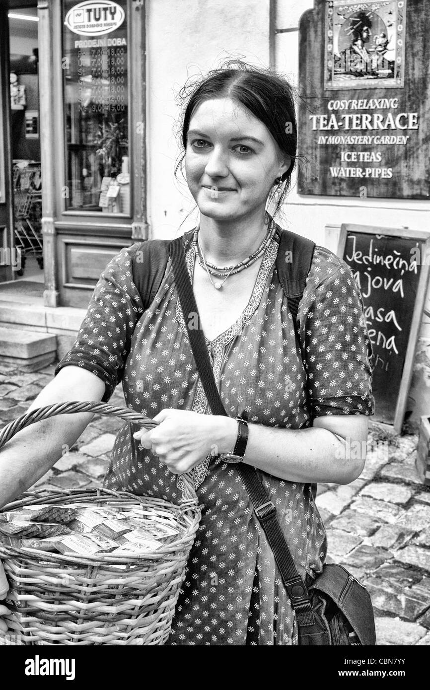 Local woman selling chocolate in tourist village of Cesky Krumlov in Czech republic Stock Photo