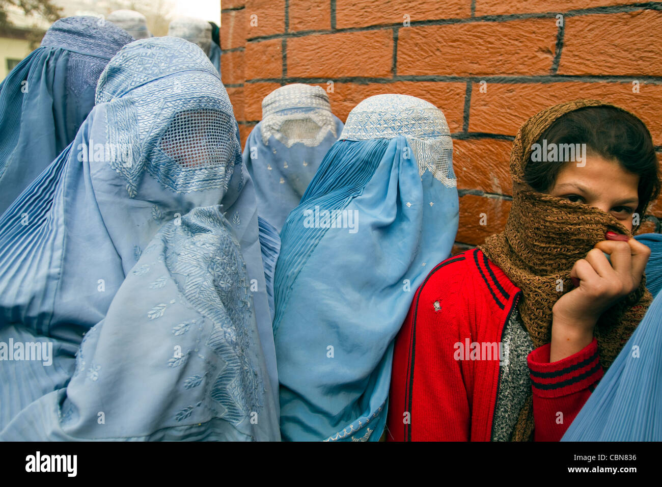 Women in burqa waiting aid for Feast of Sacrifice Kabul Afghanistan Stock Photo