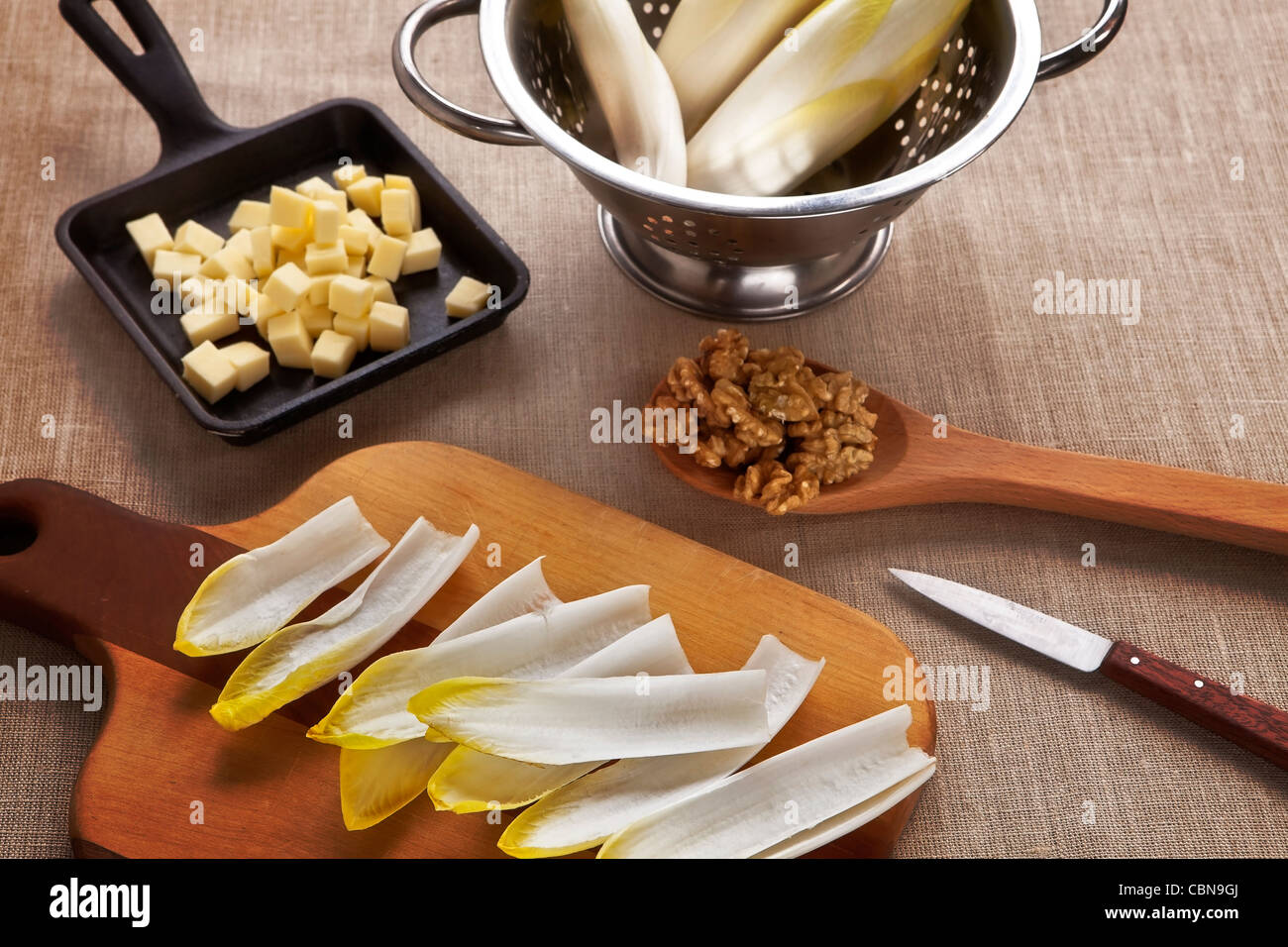 Ingredients for a salad with chicory, Swiss mountain cheese and walnuts  Stock Photo