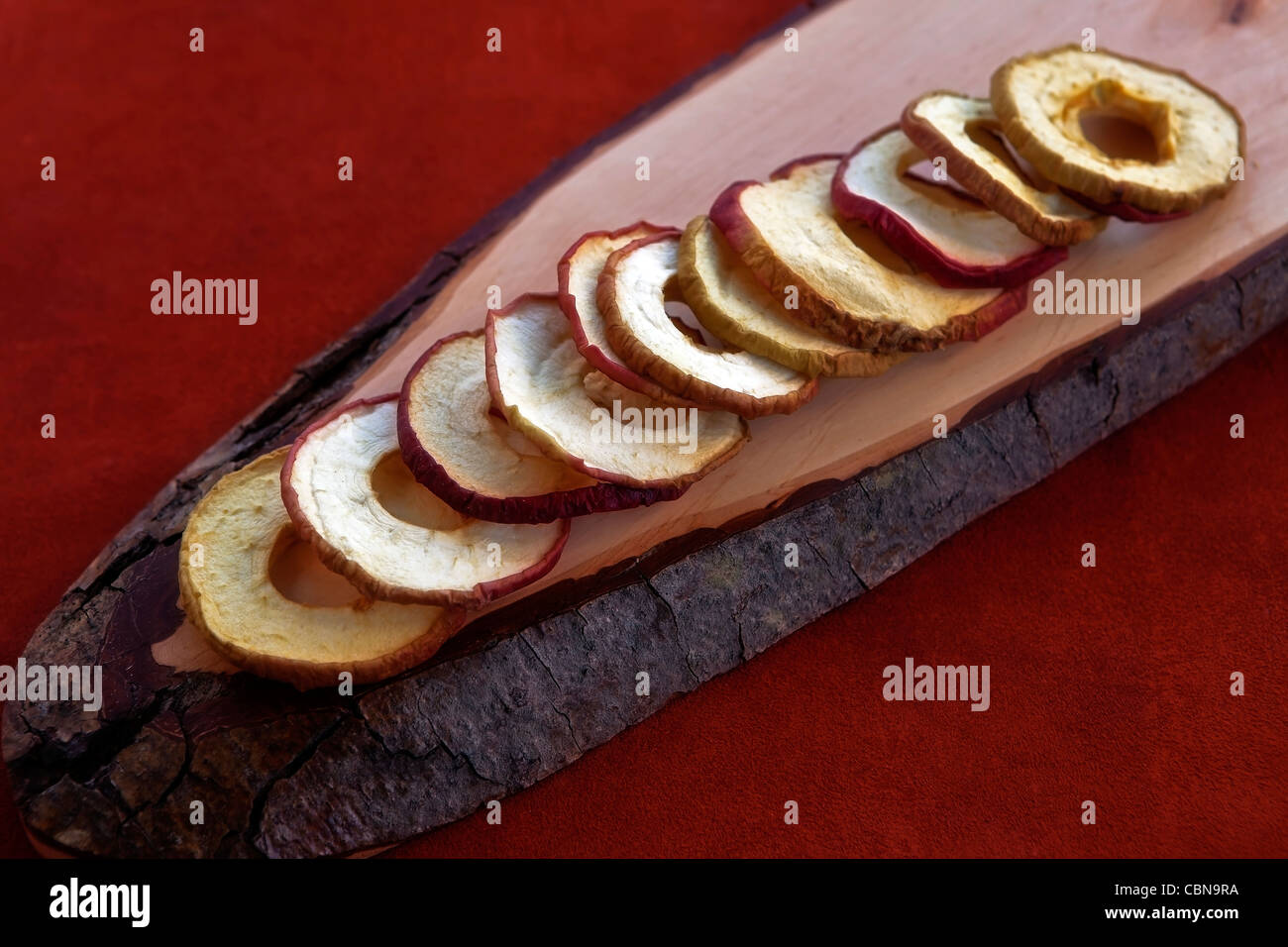 Apple chips from dried apple rings on a wooden board  Stock Photo