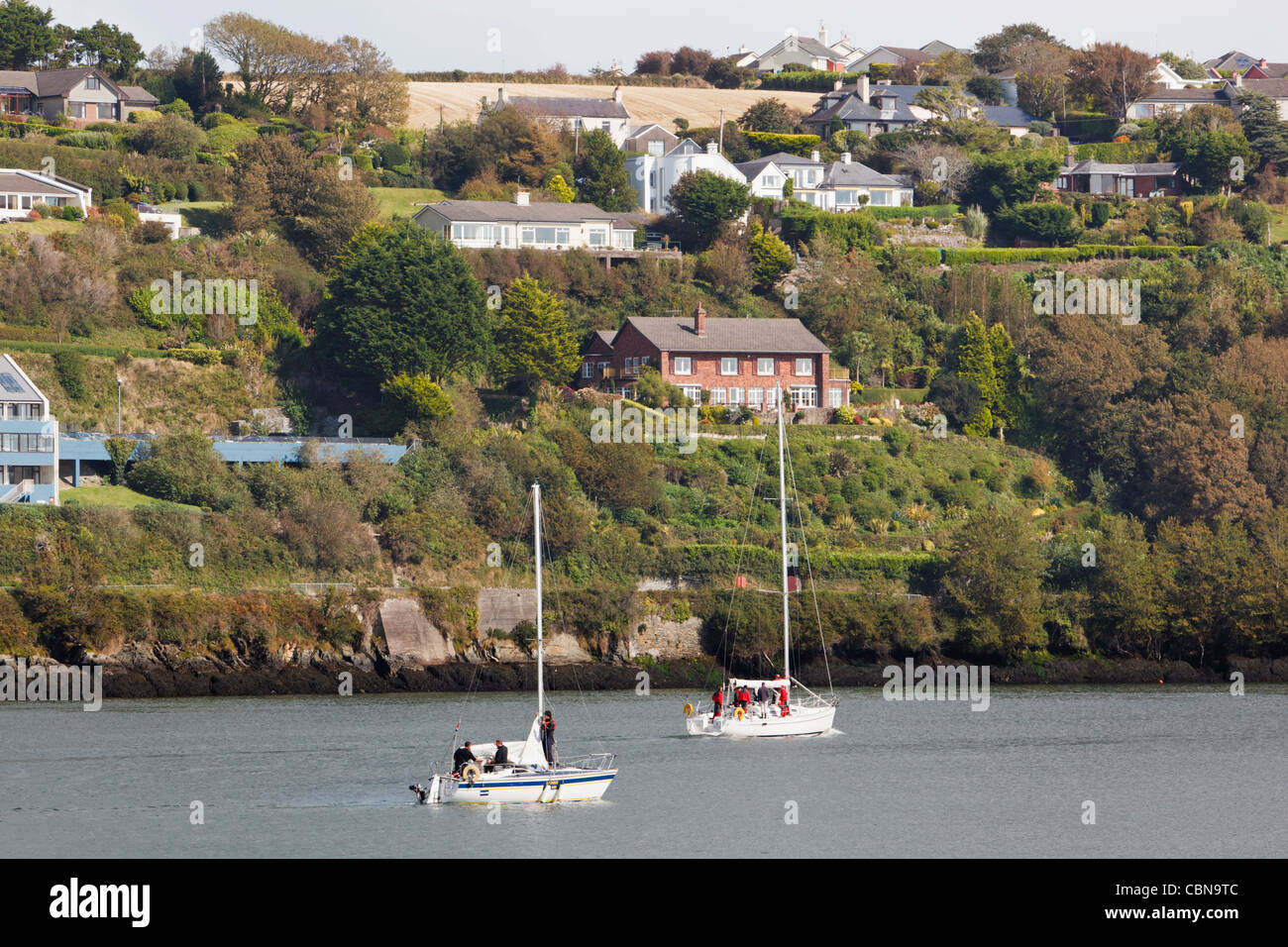 Two yachts motoring in harbour at Kinsale, County Cork, Republic of Ireland. Stock Photo