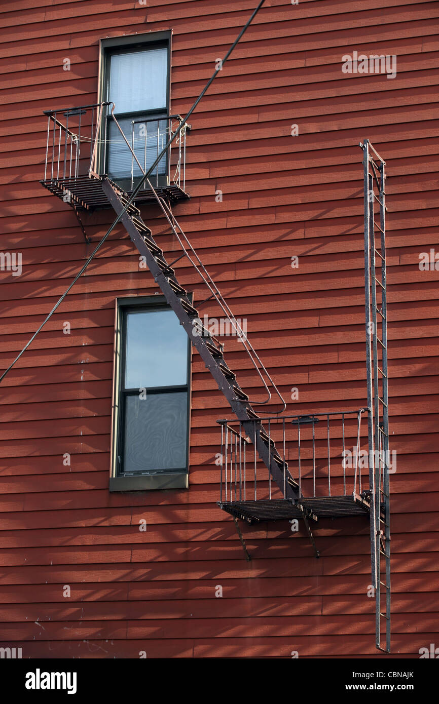 wood lap cladding wall of low rise apartment block with fire escape, Williamsburg, Brooklyn, New York City, NYC, USA Stock Photo