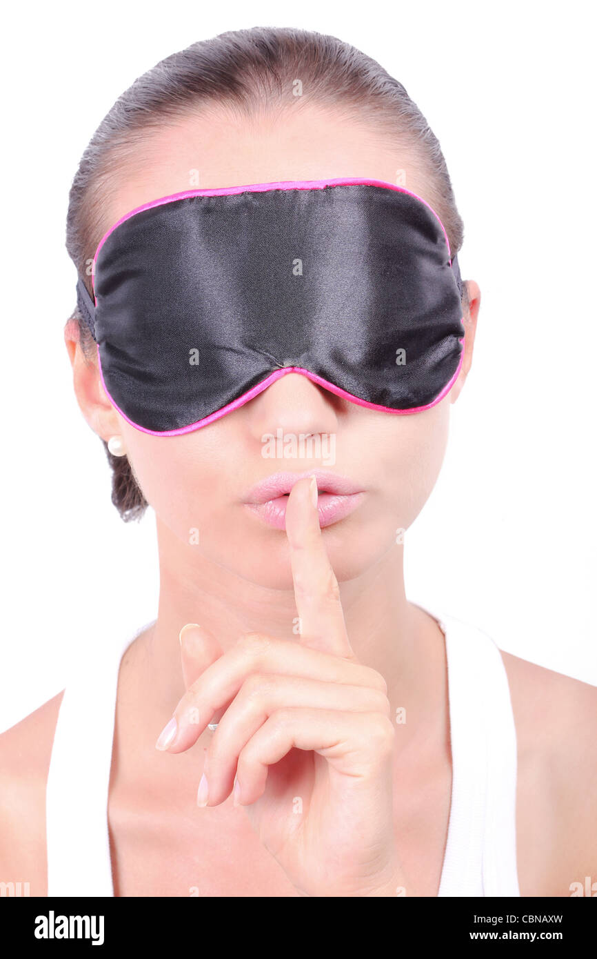 Woman in sleeping mask making a keep it quiet gesture Stock Photo - Alamy