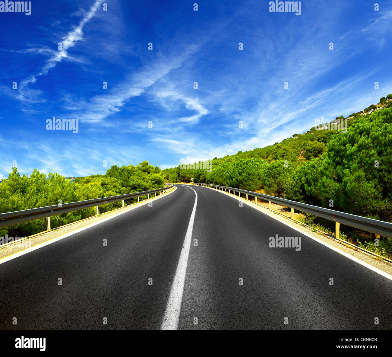 Asphalt road and blue sky with clouds Stock Photo - Alamy