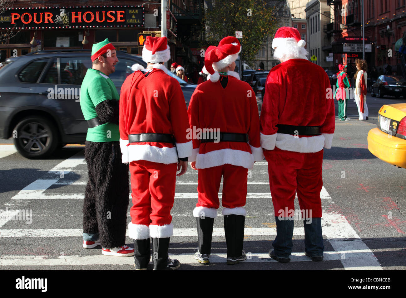 young people dressed as Santa Claus, gather in Manhattan for SantaCon 2011, New York City, NYC, USA Stock Photo