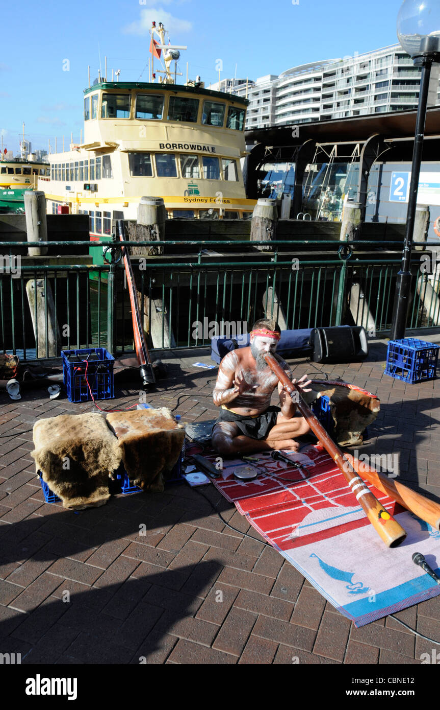 An Aboriginal busker playing his didgeridoo on Circular Quay in Sydney, New South Wales,Australia Stock Photo
