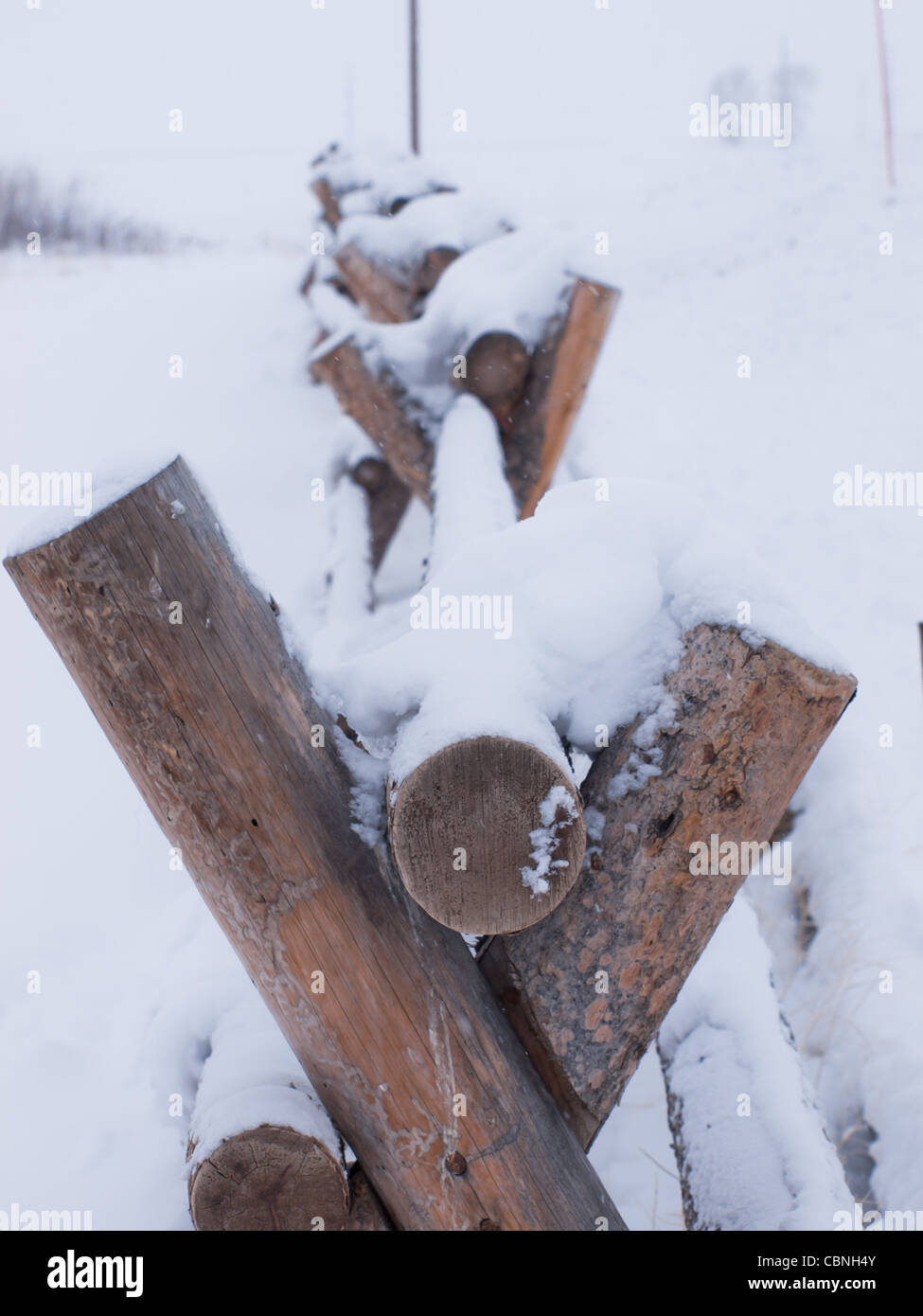 Wooden fence covered with snow Stock Photo - Alamy