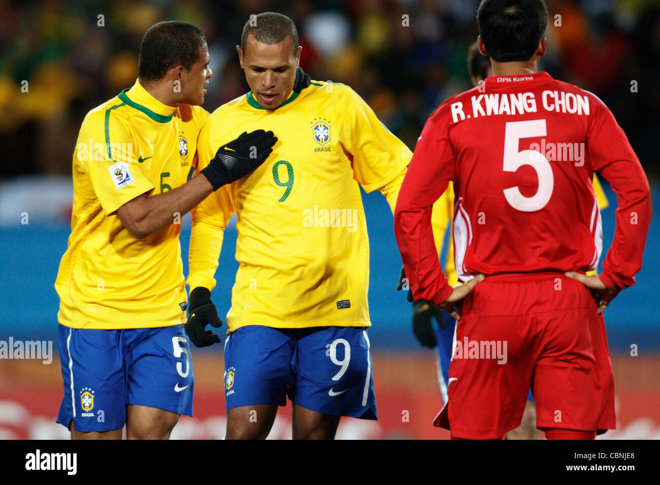 Felipe Melo of Brazil (L) talks with teammate Luis Fabiano (R) during a FIFA World Cup Group G match against North Korea. Stock Photo