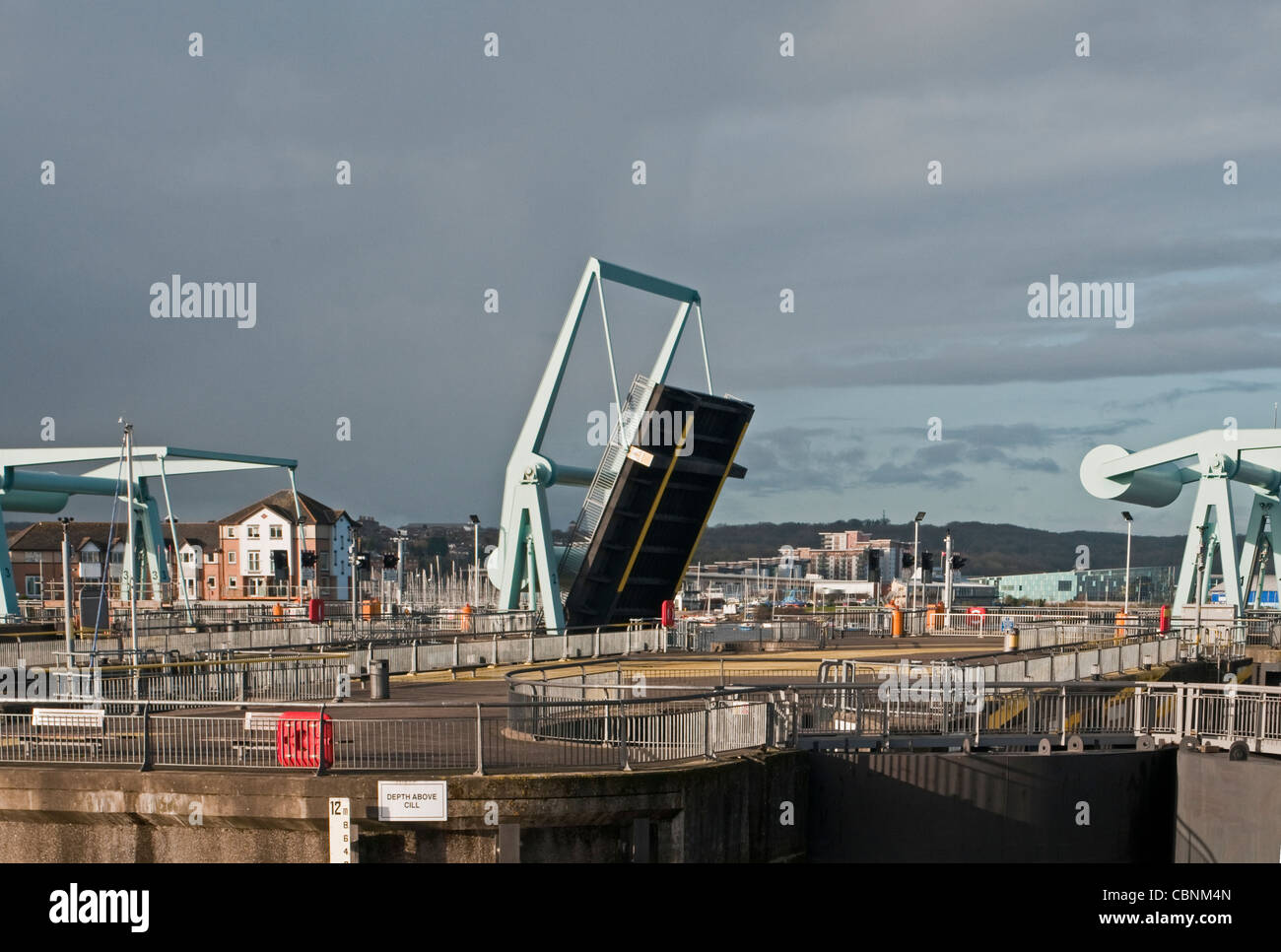 A raised bascule bridge on the Cardiff Bay barrage south Wales UK Stock Photo