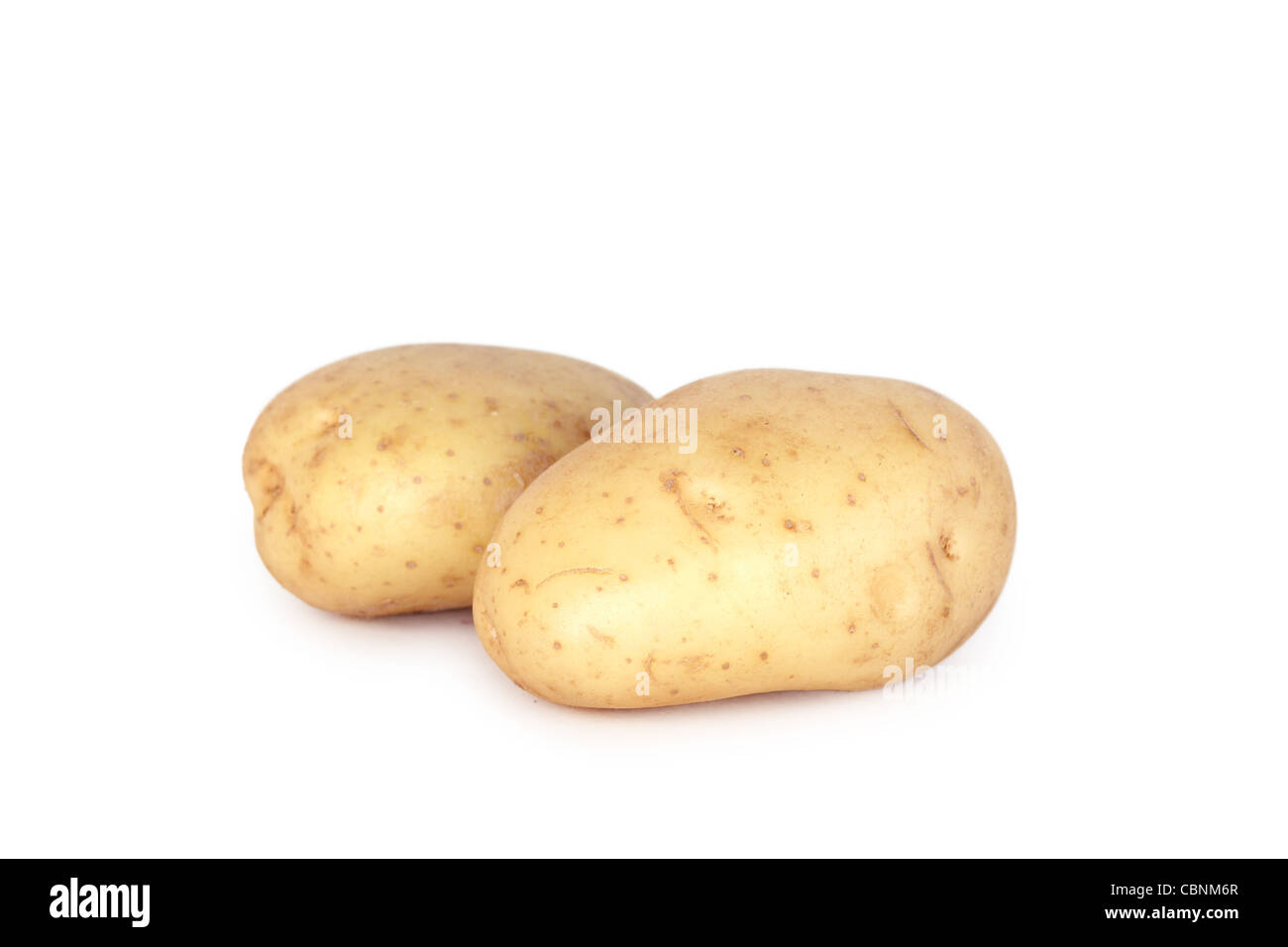 Two potatoes, closeup on white Stock Photo - Alamy