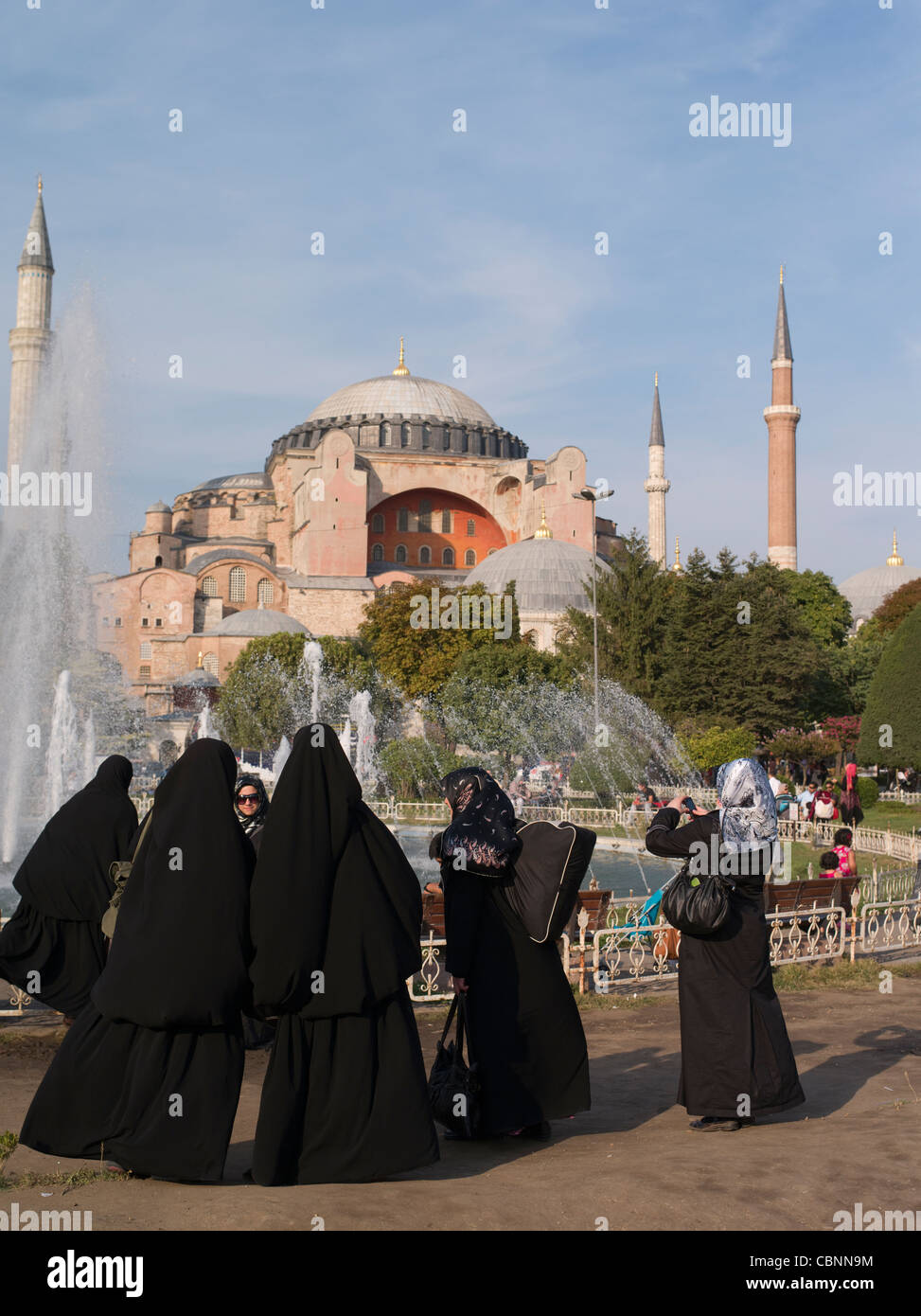 Women in abaya cloak stand in front of the Aya Sofya, Istanbul, Turkey Stock Photo