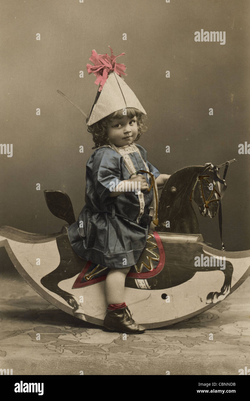 Little Child Armed with Sword Astride Rocking Horse Stock Photo