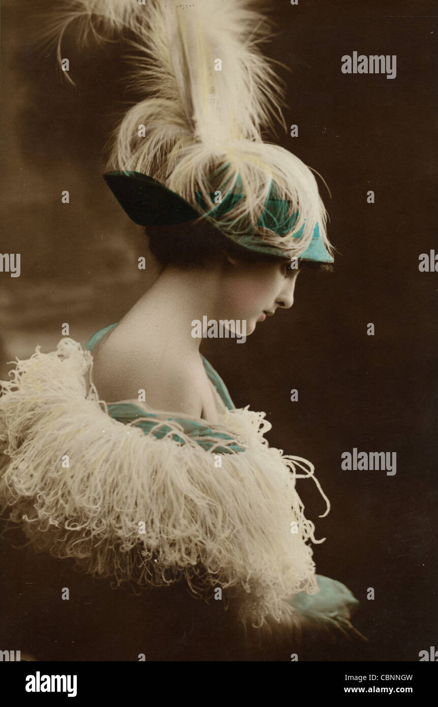 Jazz Age Beauty in Feathered Hat & Frilly Cape Stock Photo