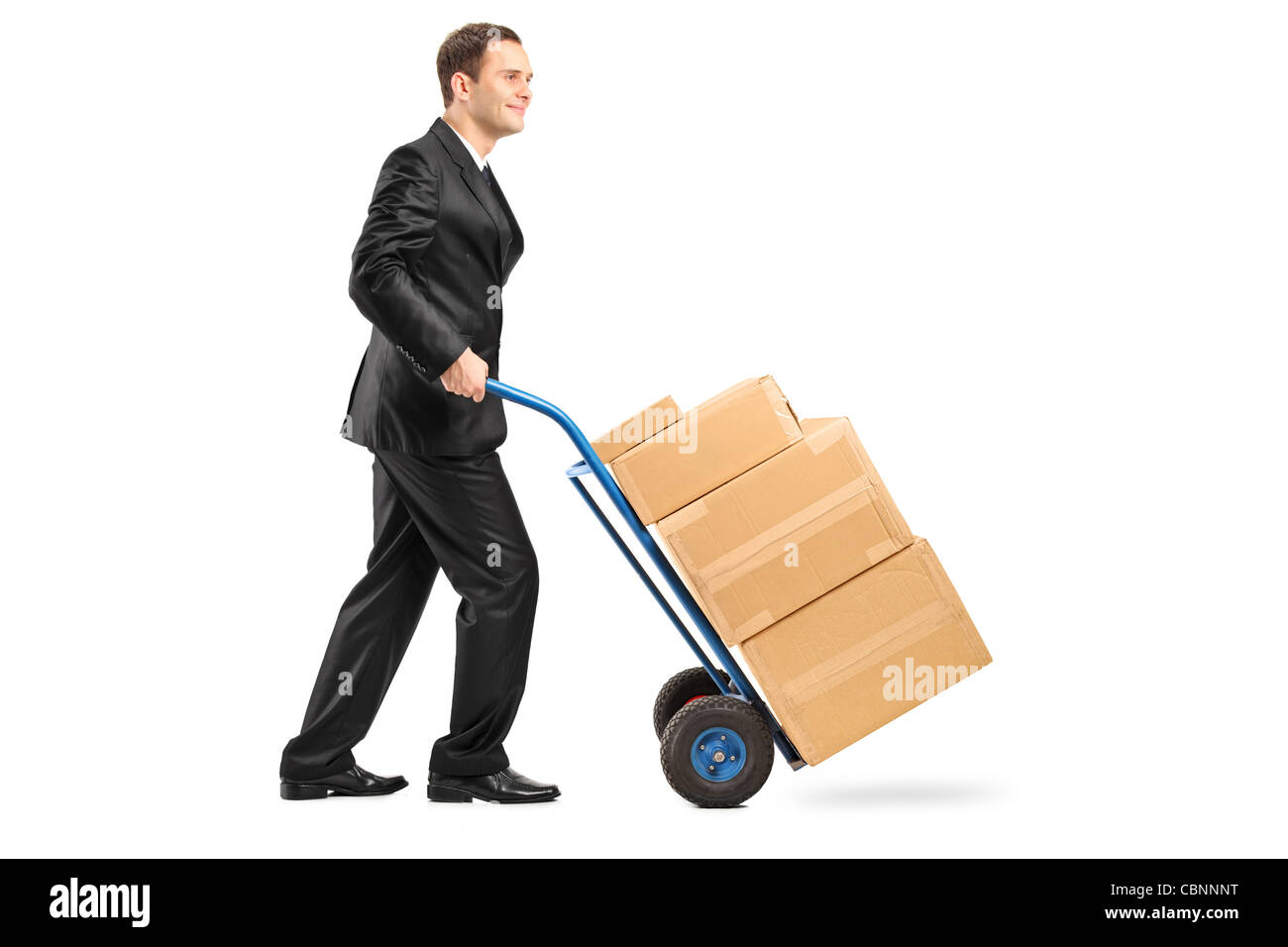 Full length portrait of a businessman pushing a hand truck full with cardboard boxes Stock Photo